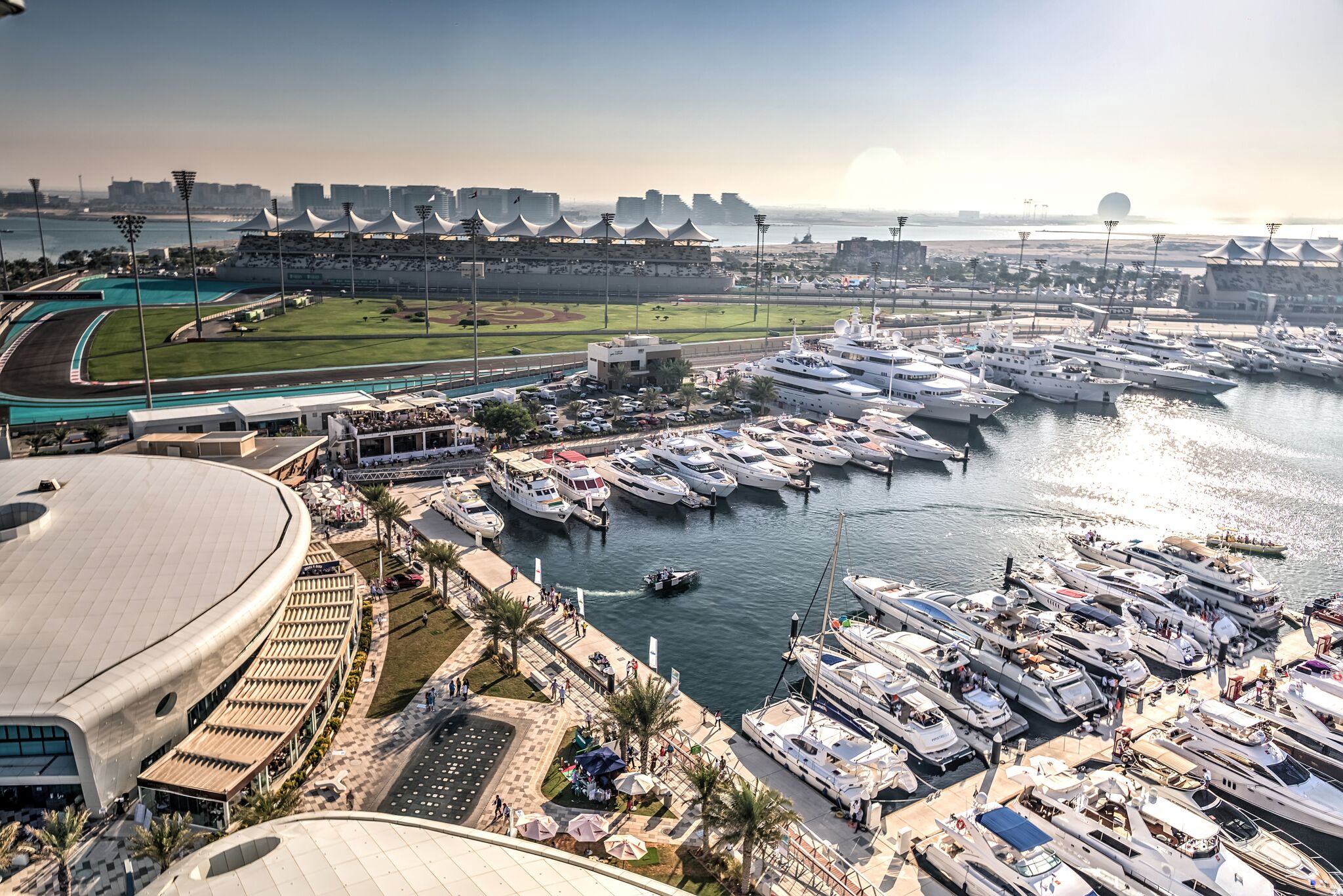 Wide view of Yas Marina Circuit showing trackside yacht berths and F1 facilities